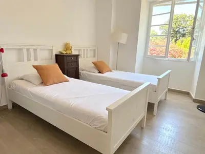 two white beds in a room with two windows at Villa Padulone in Aléria