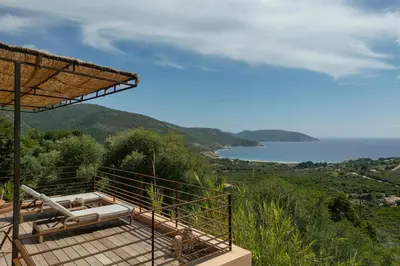 a hot tub on the side of a house with the ocean at Signura, maison entre mer et maquis in Piana