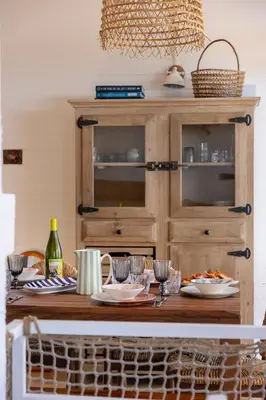 a table with plates of food and a wooden hutch at Signura, maison entre mer et maquis in Piana