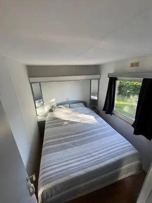 a bed in a small room with a window at I Dui Quarci in Prunelli-di-Fiumorbo