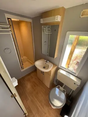 a bathroom with a sink and a toilet and a mirror at I Dui Quarci in Prunelli-di-Fiumorbo