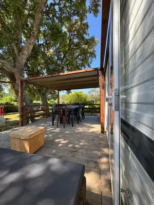 a covered patio with a table and a table at I Dui Quarci in Prunelli-di-Fiumorbo