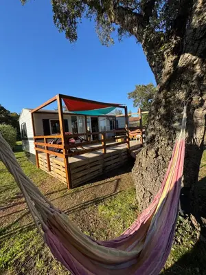 a hammock in front of a tiny house at I Dui Quarci in Prunelli-di-Fiumorbo