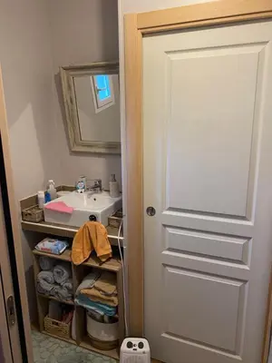 a bathroom with a sink and a white door at Casa Nustrali in Alata