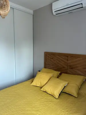 a bedroom with a bed with yellow pillows on it at Casa Nustrali in Alata
