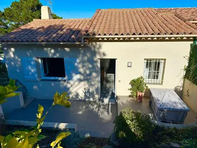 a blue and white house with a red roof at La villa Timeo in Pietrosella
