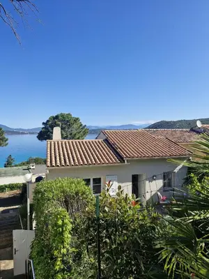 a white house with a view of the water at La villa Timeo in Pietrosella