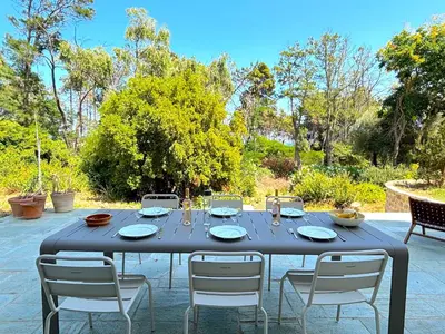 a table with four chairs and a black table cloth at L'appartement Vicente in Aléria