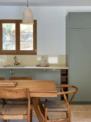 a kitchen with a wooden table and chairs at Casa di l'Ortu - Villa neuve avec piscine privée chauffée in Feliceto