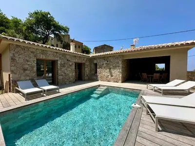 a villa with a swimming pool and a house at Casa di l'Ortu - Villa neuve avec piscine privée chauffée in Feliceto