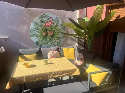 a living room with a table and a couch at Appartement Centre-Ville Propriano in Propriano