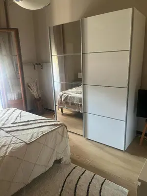 a bedroom with a large white dresser and a mirror at Appartement Centre-Ville Propriano in Propriano
