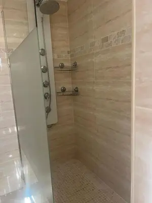 a bathroom with a shower with a glass door at Appartement Centre-Ville Propriano in Propriano