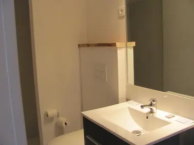 a bathroom with a sink and a mirror and a toilet at Appartement splendide vue mer in Cargèse