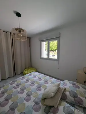 a bedroom with a bed and a window at Maison climatisée de 3 chambres avec piscine privée in Sotta