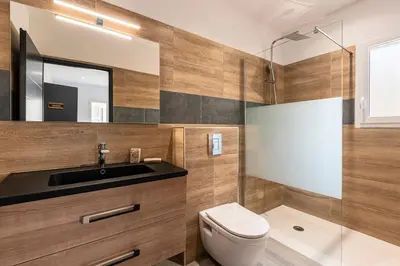 a bathroom with a toilet and a sink and a shower at Maison Mawie - Vue montagne piscine jacuzzi in Sotta
