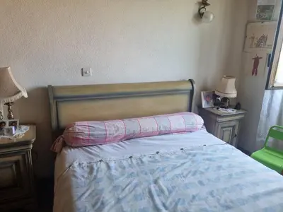 a bedroom with a bed and two night stands and two lamps at maison de village in Carbuccia