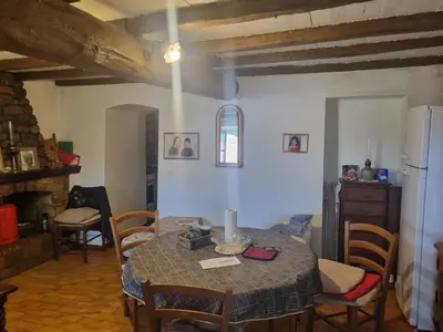 a kitchen and dining room with a table and chairs at maison de village in Carbuccia
