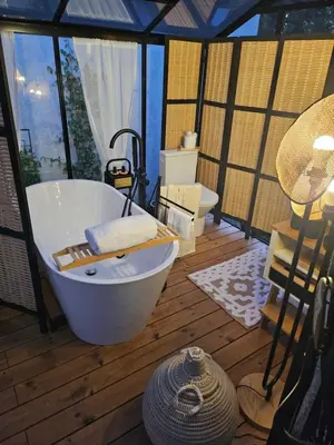 a bathroom with a bath tub in a room at L orangerie de casaoma in Prunelli-di-Fiumorbo