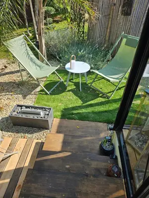 a patio with two chairs and a table and a grill at L orangerie de casaoma in Prunelli-di-Fiumorbo