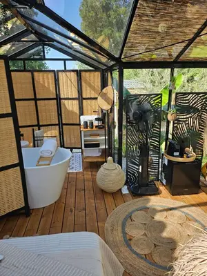 a gazebo with a bath tub on a wooden deck at L orangerie de casaoma in Prunelli-di-Fiumorbo