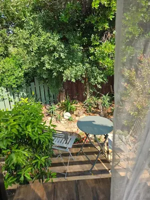 a table and a chair sitting on a patio at L orangerie de casaoma in Prunelli-di-Fiumorbo