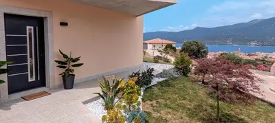 a house with a balcony with a view of the water at Sguard'Alba by vBOAS in Propriano