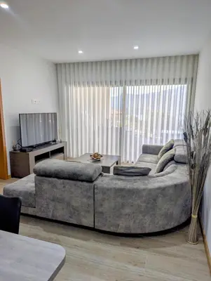 a large couch in a living room with a television at Sguard'Alba by vBOAS in Propriano