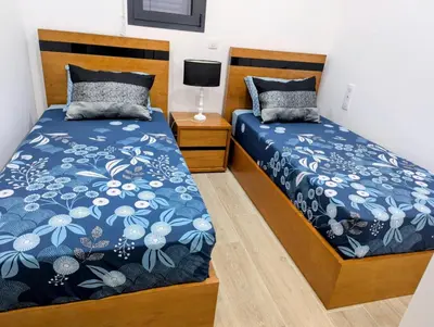 a bedroom with two beds and a tv at Sguard'Alba by vBOAS in Propriano