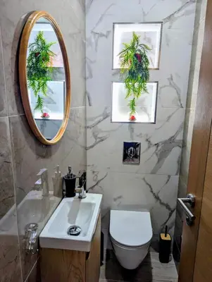 a bathroom with a sink and a toilet and a mirror at Sguard'Alba by vBOAS in Propriano