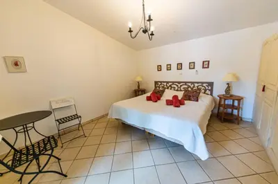 a bedroom with a bed with red pillows on it at Le Cabanon by Pinarello Villa Services in Zonza