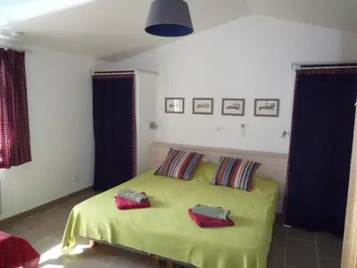 a bedroom with a bed with two pillows on it at Canopee by Pinarello Villa Services in Zonza