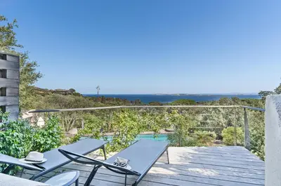 a view of the ocean from the deck of a house at Hôtel Marina di cavu in Bonifacio