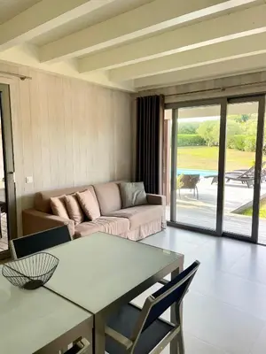 a living room with a couch and a table at Apartments PETIT DOMAIN DE SPERONE in Bonifacio