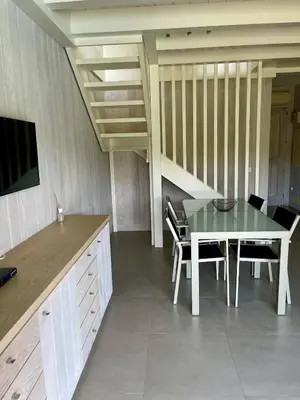 a dining room with a table and some chairs at Apartments PETIT DOMAIN DE SPERONE in Bonifacio