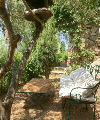 a bench and a table in a garden at Historic Villa In Sant Antonino With Sea Views in SantʼAntonino