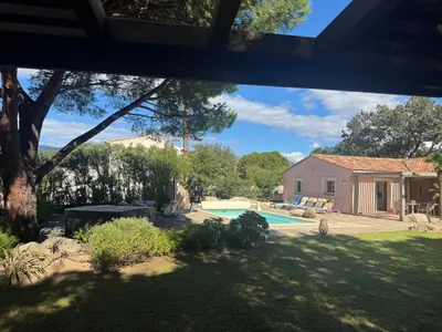 a backyard with a swimming pool and a house at Casa Flamingo in Porto-Vecchio