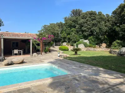 a swimming pool in the yard of a house at Casa Flamingo in Porto-Vecchio