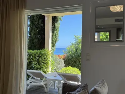 a door to a patio with a view of the ocean at T4 Cote Plage N6 face a la mer in Pinarellu