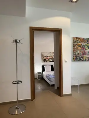 a room with a door leading to a bedroom at T4 Cote Plage N6 face a la mer in Pinarellu