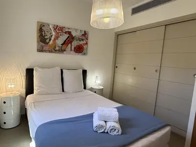a bedroom with a bed with towels on it at T4 Cote Plage N6 face a la mer in Pinarellu