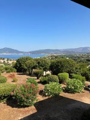 a view of a garden with bushes and trees at La Petite Felicità - Jolie Vue sur la Baie d'Ajaccio in Grosseto-Prugna