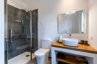 a bathroom with a toilet sink and a shower at La Villa Pianottoli - Magnifique Vue Panoramique in Pianottoli-Caldarello