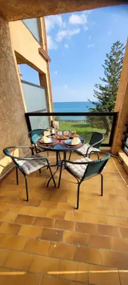 a patio with a table and chairs on a balcony at Santa Lucia Dream in Santa-Lucia-di-Moriani