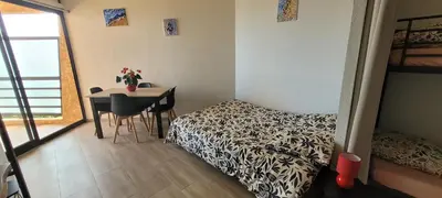 a bedroom with a bed and a table and a table and chairs at Santa Lucia Dream in Santa-Lucia-di-Moriani