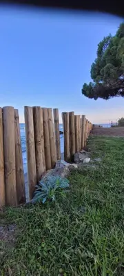 a wooden fence on the beach near the ocean at Santa Lucia Dream in Santa-Lucia-di-Moriani
