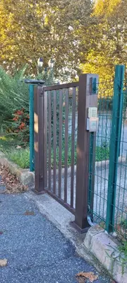 a metal gate with a parking meter next to a fence at Santa Lucia Dream in Santa-Lucia-di-Moriani