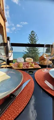a table with plates of food and wine glasses at Santa Lucia Dream in Santa-Lucia-di-Moriani