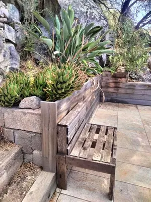 a patio with a table and chairs and plants at La Maison De Stephanie in Porto-Vecchio