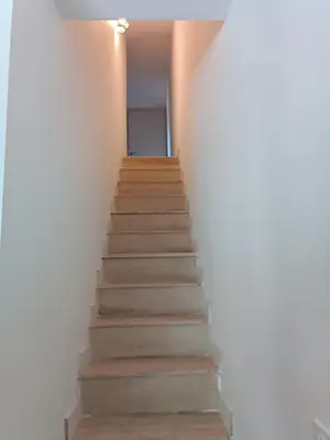 a stairway leading up to a room with white walls at Duplex Cosy- Sérénité en Bord de Mer in Borgo
